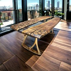 a wooden bench sitting on top of a hard wood floor next to large glass windows