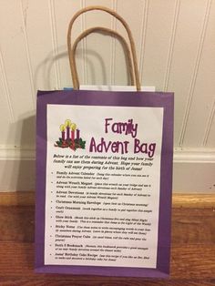 a purple paper bag with the words family adventure bag written on it sitting on a wooden floor