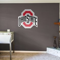 the ohio state logo is painted on a wall in a room with gray walls and carpet