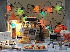 a table topped with lots of different types of food and candys on top of it