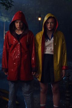 two people in raincoats standing next to each other