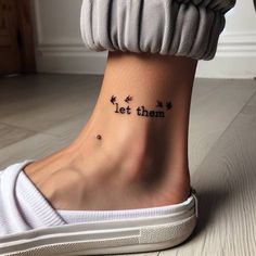 a woman's foot with the words let them tattooed on her left side ankle