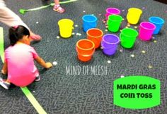 two children playing with plastic cups on the floor