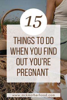 a woman sitting on the ground with text overlay that reads, 15 things to do when you find out your pregnant