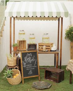 an outside area with various items on the grass and a chalkboard sign in front of it