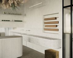 a bathroom with a counter, sink and shelves on the wall next to each other