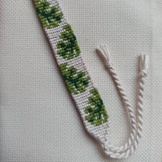 a cross stitched object sitting on top of a table