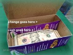 an open box with money inside sitting on a table