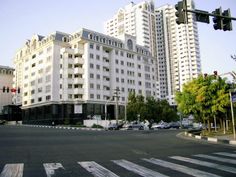 a large white building sitting on the side of a road