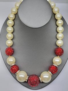 Beautiful vintage VCLM large faux pearl and red crystal pave ball necklace. This is a wonderful holiday necklace measuring 20" long and in very fine condition. I present everything in good standing, and would like you to have a wonderful and positive purchasing experience. Please don't hesitate to reach out to me with offers if you would like to talk about the price I will do what I can. Please take the time to view all pictures. I do my best to photograph the items to show all details. Please ask questions at any time. The items photographed are the actual items in current condition. Some vintage and antique pieces may have some age. I try to concentrate on abnormalities . This will be clearly photographed. Never hesitate to ask for addition photos. If any issues arise Contact me as soon Red Necklaces With Large Beads For Formal Events, Red Necklaces With Large Beads For Formal Occasions, Formal Red Necklace With Large Beads, Vintage Red Jewelry For Holidays, Red Vintage Jewelry For Holidays, Red Round Pearl Jewelry, Red Necklace For Holiday Party, Elegant Red Necklace For Holiday, Red Vintage Holiday Jewelry