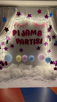 balloons and stars decorate the backdrop for a party