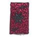 a red book with a black flower on the front and bottom cover, in an ornate pattern