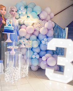 frozen princess themed birthday party with balloons and cake