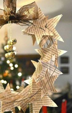 an ornament made out of old book pages and ornaments hanging from the ceiling