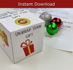 an unwrapped gift box sitting on top of a table next to some candy