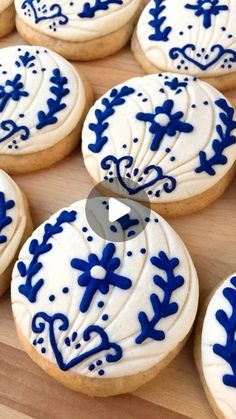 blue and white decorated cookies sitting on top of a wooden table