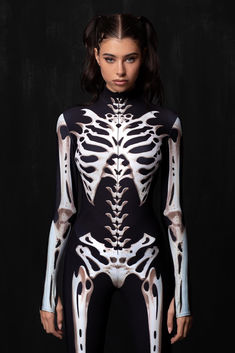 Unleash your inner extraterrestrial with this mind-bending costume that fuses alien and skeleton into one unforgettable look. Made from sleek, stretchy Lycra, it hugs your body in all the right places, while the inhuman, hybrid skeleton design creeps across your form. With strange, glowing details that pulse like alien energy, this costume takes you from human to intergalactic creature in an instant. Perfect for Halloween, this otherworldly skeleton design will have everyone questioning if you’ve come to party or invade! FEATURES: > Mock Neckline > Robust & Hidden Front Zipper Closure > Long Sleeves > 82% Polyester 18% Elastane > Non-Transparent Lycra > 30° Cold Wash, Hang dry Bone Costume, Open Front Skirt, Dragon Bones, Long Fingerless Gloves, Bodysuit And Skirt, Skeleton Design, Living Your Best Life, Full Body Suit, Festival Costumes