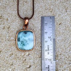 The most beautiful gemstone found only in the Dominican Republic, Larimar is a stone of coolness and calm, much like the native waters it resembles. Larimar is a powerful healer! It can help with panic attacks, anger, fear and other stress-related issues. Secure this unique and beautiful one-of-a-kind Larimar pendant around your neck and breathe in the calm of the Caribbean ocean! Includes a 22" copper-plated snake chain (electroplated brass in antique copper color) Lead-free; nickel-safe Bezel-set in copper Pendant is approximately 1.49”H (37.8mm) x .84”W (21.3mm) Comes in our exclusive luxury gift box Source: Dominican Republic Any visible imperfections and/or cracks are due to natural formation Product color may slightly vary due to photographic lighting sources! Disclaimer: Crystals sh Caribbean Ocean, Orange Stone, Larimar Pendant, Book Jewelry, The Dominican Republic, Copper Pendant, Clear Stone, Purple Stones, Luxury Gift Box