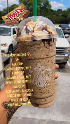 a person holding up a starbucks drink with information about the drinks in front of them