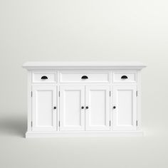 a white cabinet with four doors and three drawers