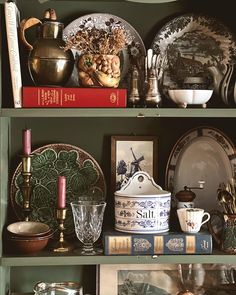 the shelves are filled with dishes and other things on top of each shelf in front of them