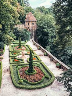 the garden is surrounded by hedges and trees