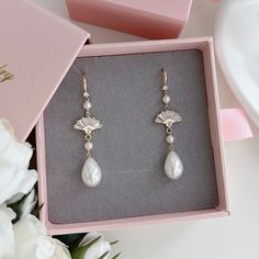 * DETAILS * - Synthetic Teardrop Shaped Pearls - 18K gold plated on brass Fan Shape Charms size 14mm - CZ Paved Gold Plated Earring Hooks  ✨more earrings. www.Etsy.com/shop/JinnysJewelryBySeJin ✨matching necklace. https://www.etsy.com/JinnysJewelryBySeJin/listing/1259481767/14k-gold-filled-lariat-necklace-y-pearl?utm_source=Copy&utm_medium=ListingManager&utm_campaign=Share&utm_term=so.lmsm&share_time=1656461004761 https://www.etsy.com/JinnysJewelryBySeJin/listing/1288884895/wedding-jewelry-set-lariat-necklace-y?utm_source=Copy&utm_medium=ListingManager&utm_campaign=Share&utm_term=so.lmsm&share_time=1660964299342 🎁A designer pull drawer PINK GIFT BOX is available when the gift wrapping option is chosen. . ------------------------------------------ * CARE TIPS * ⭐️TO PREVENT TARNISH: Keep y Dangle Brass Jewelry For Wedding, Brass Dangle Jewelry For Weddings, Elegant Brass Dangle Jewelry For Weddings, Teardrop Clip-on Earrings For Wedding, Wedding Pearl Drop Brass Earrings, Wedding Pearl Drop Earrings In Brass, Delicate Brass Wedding Earrings, White Brass Pearl Earrings For Wedding, Gold Brass Pearl Earrings For Wedding