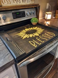 a stove top with a sign on it that says, blessing and a potted plant