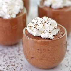 three small desserts with whipped cream on top