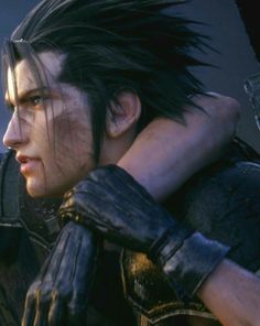 an image of a man with black hair and leather gloves looking off into the distance