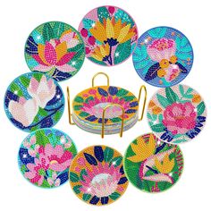 a set of nine colorful plates with flowers on them