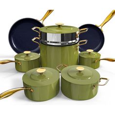 a set of green pots and pans with gold handles are shown in this image