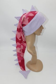 "This listing is for the hat pictured, you will receive this exact hat.  Who wouldn't want an absolutely awesome hat that can be a scarf too?? This hat is 24-36\" long from brim to end spike and is can wrap around your neck for added warmth! With its eye-catching pattern and long row of spikes, everyone you encounter will wonder where you got such a great hat and will want one for themselves! Hat is sized to fit any ages from 4 years old and up- fits kids, adults, and teens alike. Extra stretchy Ski Hat, Fleece Dinosaur Hat Pattern Free, Fleece Dragon Hat Pattern, Novelty Beanie For Cosplay, Novelty Cat Ears Winter Hat, Fun Pink Beanie Hat, Dinosaur Tails, Silly Clothes, Purple Camo