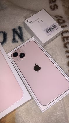 two new iphones are in the box and one is pink