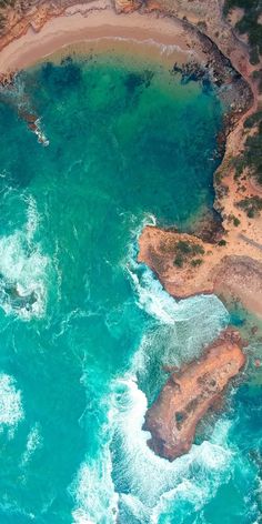 an aerial view of the ocean and land