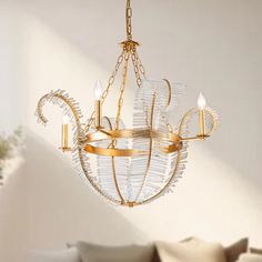 a chandelier hanging from a ceiling in a room with white walls and pillows