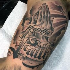 a man's arm with a praying hand and the words faith written on it