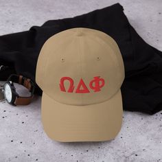 "Unveiling the trendy Omega Delta Phi Classic Hat! This accessory, crafted with precision, flaunts your fraternity name in bold embroidery, signifying your pride and membership. The premium-grade thread promises distinct, clean, and crisp letters, showcasing your Omega Delta Phi affiliation with sophistication. As a proudly licensed product, this hat ensures your Greek pride gets the recognition it deserves. More than an accessory, this hat is a year-round testament of your Greek pride. Wear it to fraternity events, meetings, or daily routines to show your commitment to Omega Delta Phi. Its stylish design and Greek pride display are sure to spark conversations in your community. Breaking the 'dad hat' stereotype, this hat combines trendy appeal with comfort. It boasts an unstructured form, Omega Delta Phi, Bold Embroidery, Pride Wear, Classic Hats, Camo Colors, Green Camo, Fraternity, Trucker Cap, Unisex Fashion