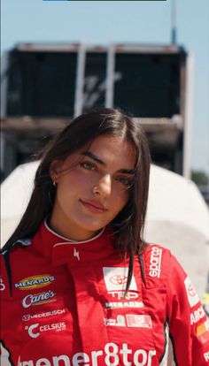 a woman in a racing uniform posing for the camera