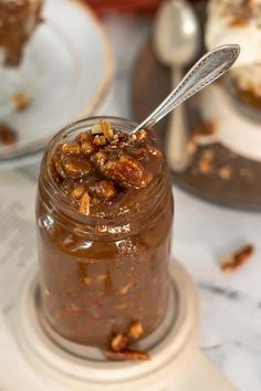 a spoon in a jar filled with food