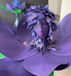 a purple flower with a woman's face on it