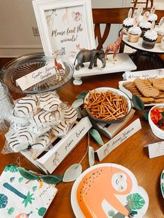 a wooden table topped with plates and desserts