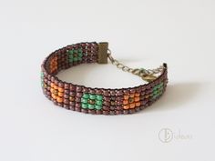 Bracelet made of multicolored glass beads in combination with a metal or leather chain. Brown Bracelets With Large Beads For Festival, Brown Bracelets With Tiny Beads As Gift, Brown Bracelets With Tiny Beads For Gift, Brown Jewelry With Colorful Beads, Brown Beaded Bracelets With Round Beads For Festivals, Colorful Round Bead Metal Bracelets, Colorful Beaded Metal Bracelets, Multicolor Metal Beaded Bangle Bracelets, Colorful Round Beaded Metal Bracelets