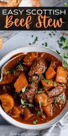 beef stew in a white bowl with bread and parsley sprig on the side