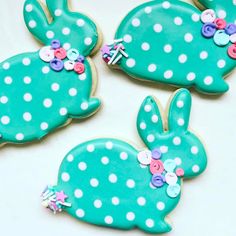 three decorated cookies in the shape of rabbits