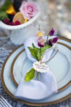 a place setting with napkins and flowers