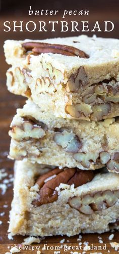 three pieces of shortbread stacked on top of each other with pecans in the middle