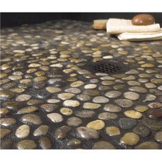 a close up of rocks on a grill with a spatula and towel in the background