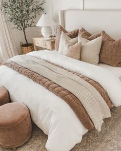 a bed with pillows and blankets on top of it