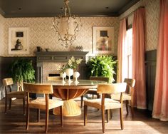 a dining room table with chairs and a chandelier hanging from it's ceiling